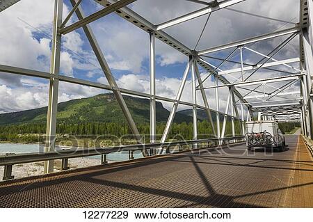 Car and trailer crossing a metal bridge over the Racing River, Alaska Highway, West of Fort Nelson, British Columbia, Canada, Summer View Large Photo Image Stock Photo - Car and trailer crossing a metal bridge over the Racing River, Alaska Highway, West of Fort Nelson, British Columbia, Canada, Summer. Fotosearch