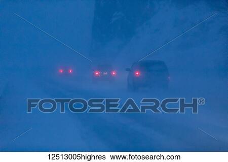 Car tail lights illuminate the blowing snow on the Seward Highway during a dark, winter night, Turnagain Arm, Kenai Peninsula, South-central Alaska; Alaska, United States of America View Large Photo Image Stock Photograph - Car tail lights illuminate the blowing snow on the Seward Highway during a dark, winter night, Turnagain Arm, Kenai Peninsula, South-central Alaska; Alaska, United States of America. Fotosearch