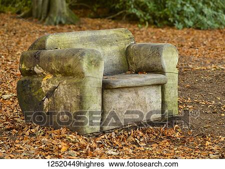 Carved wooden chair sitting on the ground covered with fallen autumn coloured leaves, near Belsay; Northumberland, England View Large Photo Image Stock Photograph - Carved wooden chair sitting on the ground covered with fallen autumn coloured leaves, near Belsay; Northumberland, England. Fotosearch