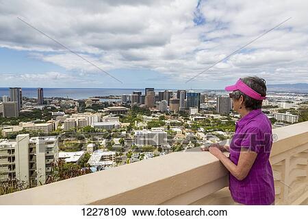Close up of a tourist looking out at downtown Honolulu; Honolulu, Oahu, Hawaii, United States of America View Large Photo Image Stock Photo - Close up of a tourist looking out at downtown Honolulu; Honolulu, Oahu, Hawaii, United States of America. Fotosearch