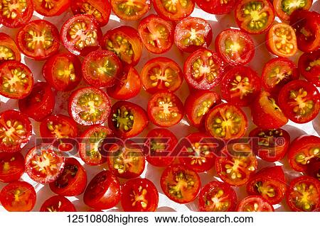 Stock Photograph - Close-up of halved cherry tomatoes. Fotosearch