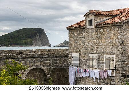 Stock Photograph - Clothesline outside an old stone house along the coast of the Adriatic Sea; Budva, Opstina Budva, Monte. Fotosearch