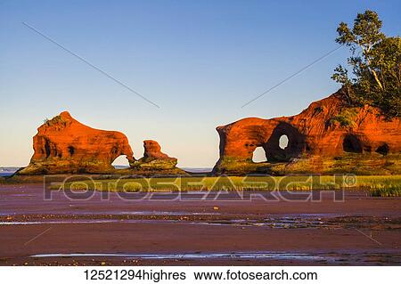 Coastal sea stacks and beach at low tide at sunset along the Minas Basin shoreline; North Medford, Nova Scotia, Canada View Large Photo Image Stock Photograph - Coastal sea stacks and beach at low tide at sunset along the Minas Basin shoreline; North Medford, Nova Scotia, Canada. Fotosearch