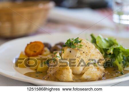 Stock Photograph - Cod dinner on a plate, Langaholt, Iceland. Fotosearch