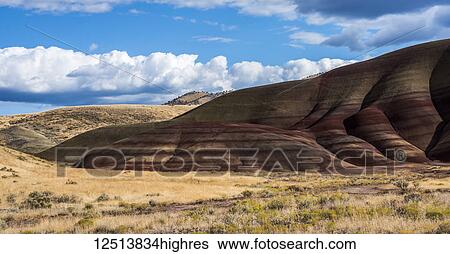 Stock Photograph - Colourful layers of minerals are exposed at John Day Fossil Beds National Monument. No grass grows on the Painted Hills Unit; Mitchell, Oregon, United States of America. Fotosearch