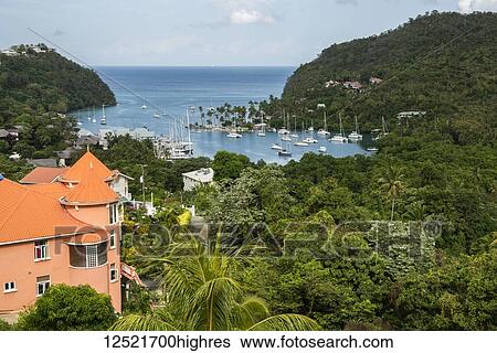 Stock Photograph - Colourful orange roof of house near Marigot Bay harbour, near Castrias; Saint Lucia. Fotosearch