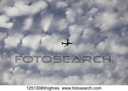 Commercial aircraft in the clouds; Brampton, Ontario, Canada View Large Photo Image Stock Photograph - Commercial aircraft in the clouds; Brampton, Ontario, Canada. Fotosearch