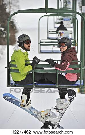 Couple ride the chair lift at Hilltop Ski Area in Anchorage, Alaska View Large Photo Image Stock Image - Couple ride the chair lift at Hilltop Ski Area in Anchorage, Alaska. Fotosearch