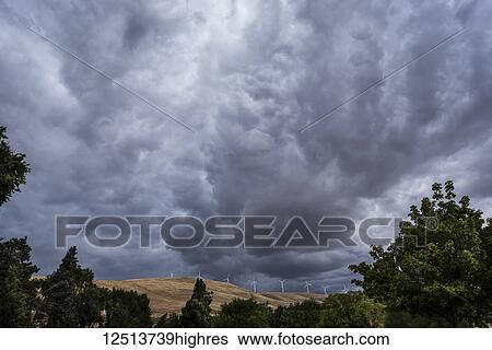Dark clouds loom over Klickitat County with wind turbines on the hills; Maryhill, Washington, United States of America View Large Photo Image Stock Photograph - Dark clouds loom over Klickitat County with wind turbines on the hills; Maryhill, Washington, United States of America. Fotosearch