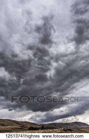 Dark clouds loom over Klickitat County with wind turbines on the hills; Maryhill, Washington, United States of America View Large Photo Image Stock Photograph - Dark clouds loom over Klickitat County with wind turbines on the hills; Maryhill, Washington, United States of America. Fotosearch