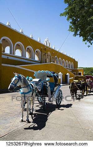 Stock Photograph - Decorated horses and carriages for tourists in the street; Izamal, Yucatan, Mexico. Fotosearch