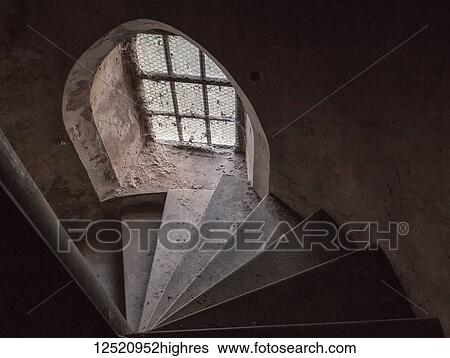 Derelict spiral stone staircase lit by an arched window; England View Large Photo Image Stock Photograph - Derelict spiral stone staircase lit by an arched window; England. Fotosearch