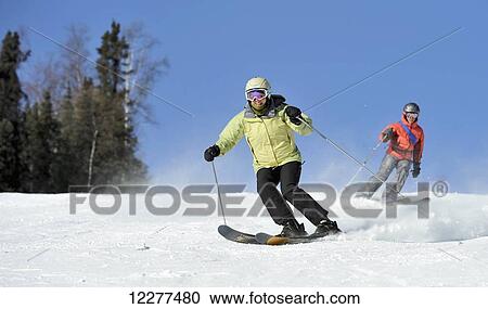 Stock Image - Downhill skiers at Mt. Aurora Skiland near Cleary Summit north of Fairbanks, Alaska. Fotosearch