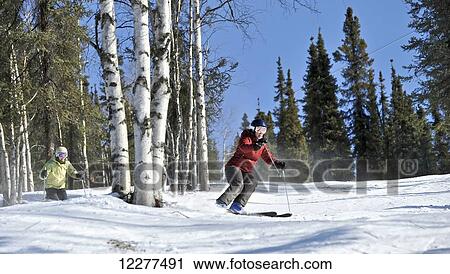 Stock Image - Downhill skiers at Mt. Aurora Skiland near Cleary Summit north of Fairbanks, Alaska. Fotosearch
