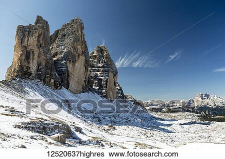 Dramatic mountain spires on top of snow-covered rocky plateau and blue sky; Sesto, Bolzano, Italy View Large Photo Image Stock Photograph - Dramatic mountain spires on top of snow-covered rocky plateau and blue sky; Sesto, Bolzano, Italy. Fotosearch
