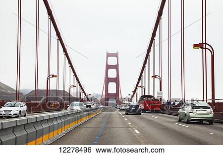Stock Photograph - Driving across the Golden Gate Bridge on a foggy morning; San Francisco, California, United States of America. Fotosearch