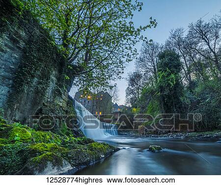 Stock Photograph - Edinburgh waterfall surrounded by medieval buildings; Edinburgh, Scotland. Fotosearch