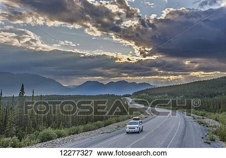 Stock Photo - Evening sunset view of the Alaska Highway near Kluane Lake, Yukon Territory, Canada, HDR. Fotosearch