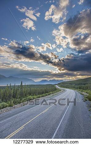 Evening sunset view of the Alaska Highway near Kluane Lake, Yukon Territory, Canada, HDR View Large Photo Image Stock Photo - Evening sunset view of the Alaska Highway near Kluane Lake, Yukon Territory, Canada, HDR. Fotosearch