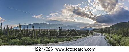 Stock Photograph - Evening sunset view of the Alaska Highway near Kluane Lake, Yukon Territory, Canada, HDR. Fotosearch