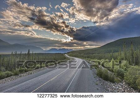 Stock Photography - Evening sunset view of the Alaska Highway near Kluane Lake, Yukon Territory, Canada, HDR. Fotosearch