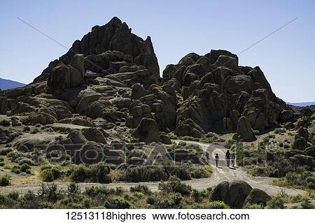 Stock Photograph - Family walking down a road in the Alabama Hills; California, United States of America. Fotosearch