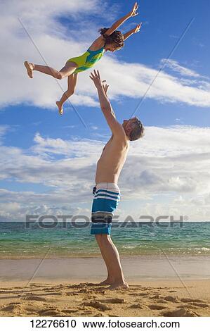 Father and daughter playing on a beach; Kailua, Island of Hawaii, Hawaii, United States of America View Large Photo Image Stock Image - Father and daughter playing on a beach; Kailua, Island of Hawaii, Hawaii, United States of America. Fotosearch