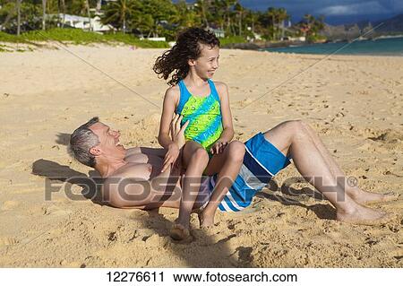 Father and daughter playing on a beach; Kailua, Island of Hawaii, Hawaii, United States of America View Large Photo Image Stock Image - Father and daughter playing on a beach; Kailua, Island of Hawaii, Hawaii, United States of America. Fotosearch