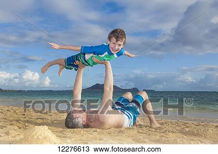 Father and son playing at the beach; Kailua, Island of Hawaii, Hawaii, United States of America View Large Photo Image Stock Image - Father and son playing at the beach; Kailua, Island of Hawaii, Hawaii, United States of America. Fotosearch