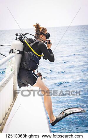 Female diver doing giant stride off dive boat; Negril, Jamaica View Large Photo Image Stock Photograph - Female diver doing giant stride off dive boat; Negril, Jamaica. Fotosearch