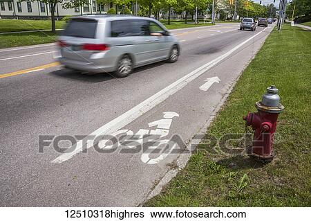 Fire hydrant next to a street with a bicycle lane and a vehicle going by; Vermont, United States of America View Large Photo Image Stock Photograph - Fire hydrant next to a street with a bicycle lane and a vehicle going by; Vermont, United States of America. Fotosearch