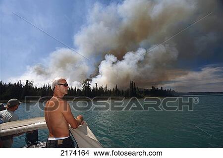 Fishermen Watch Forest Fire From The Safety Of A Boat On Skilak Lake, Kenai Wildlife Refuge, Kp Alaska. View Large Photo Image Picture - Fishermen Watch Forest Fire From The Safety Of A Boat On Skilak Lake, Kenai Wildlife Refuge, Kp Alaska.. Fotosearch