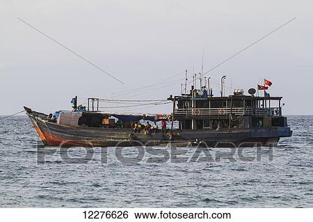 Fishing boat in Dili harbour; Dili, East Timor View Large Photo Image Stock Photograph - Fishing boat in Dili harbour; Dili, East Timor. Fotosearch