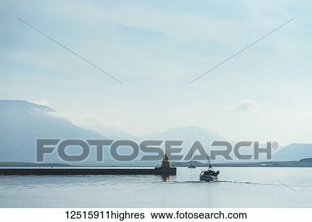Stock Photograph - Fishing boat leaving Reykjavik harbour on a calm morning; Reykjavik, Iceland. Fotosearch