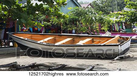 Fishing boat moored near shop selling colourful clothing in the Caribbean; Anse La Raye, Saint Lucia View Large Photo Image Stock Photograph - Fishing boat moored near shop selling colourful clothing in the Caribbean; Anse La Raye, Saint Lucia. Fotosearch