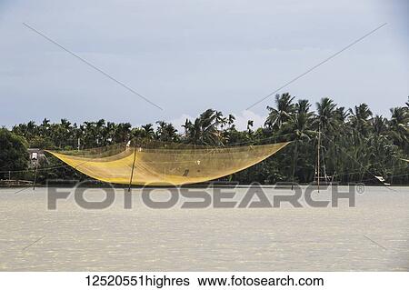 Stock Photograph - Fishing net over the river; Hoi An, Quang Nam, Vietnam. Fotosearch