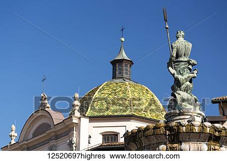 Fountain top with colourful dome of a church and blue sky in the background; Trento, Trento, Italy View Large Photo Image Stock Photograph - Fountain top with colourful dome of a church and blue sky in the background; Trento, Trento, Italy. Fotosearch