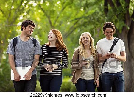 Four friends walking and talking together on the university campus; Edmonton, Alberta, Canada View Large Photo Image Stock Photograph - Four friends walking and talking together on the university campus; Edmonton, Alberta, Canada. Fotosearch