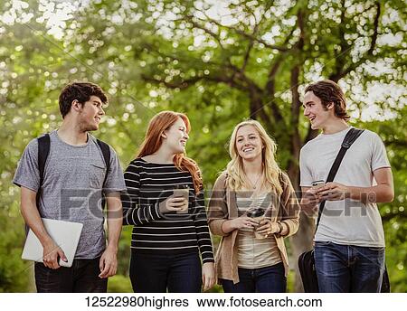 Four friends walking and talking together on the university campus; Edmonton, Alberta, Canada View Large Photo Image Stock Photograph - Four friends walking and talking together on the university campus; Edmonton, Alberta, Canada. Fotosearch
