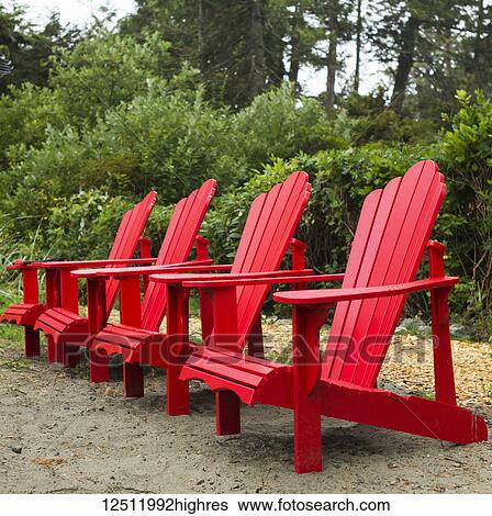 Four red Adirondack chairs in a row on Chesterman Beach, Vancouver Island, Pacific Rim; Tofino, British Columbia, Canada View Large Photo Image Stock Photograph - Four red Adirondack chairs in a row on Chesterman Beach, Vancouver Island, Pacific Rim; Tofino, British Columbia, Canada. Fotosearch