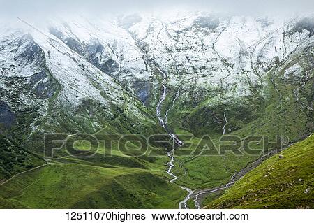 Fresh snow dusted on Lanchettes mountain range over green meadow, France-Italy border; France View Large Photo Image Stock Photograph - Fresh snow dusted on Lanchettes mountain range over green meadow, France-Italy border; France. Fotosearch