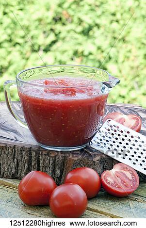 Stock Photograph - Freshly grated tomatoes into a sauce. Fotosearch