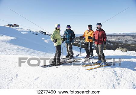 Stock Image - Friends gather at the top of Mt. Aurora Skiland for a day of downhill skiing near Cleary Summit north of Fairbanks, Alaska. Fotosearch