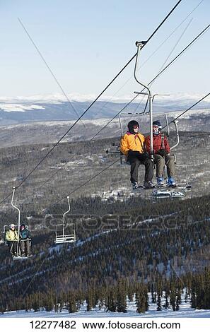Friends ride the 3800-feet double chairlift at Mt. Aurora Skiland near Cleary Summit north of Fairbanks, Alaska. View Large Photo Image Stock Image - Friends ride the 3800-feet double chairlift at Mt. Aurora Skiland near Cleary Summit north of Fairbanks, Alaska.. Fotosearch