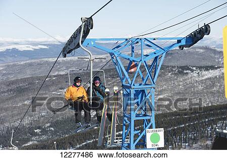Friends ride the 3800-feet double chairlift at Mt. Aurora Skiland near Cleary Summit north of Fairbanks, Alaska. View Large Photo Image Stock Photograph - Friends ride the 3800-feet double chairlift at Mt. Aurora Skiland near Cleary Summit north of Fairbanks, Alaska.. Fotosearch