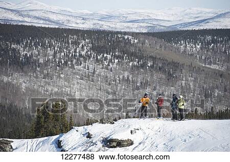 Friends take in the view during a day of downhill skiing at Mt. Aurora Skiland near Cleary Summit north of Fairbanks, Alaska View Large Photo Image Stock Photo - Friends take in the view during a day of downhill skiing at Mt. Aurora Skiland near Cleary Summit north of Fairbanks, Alaska. Fotosearch
