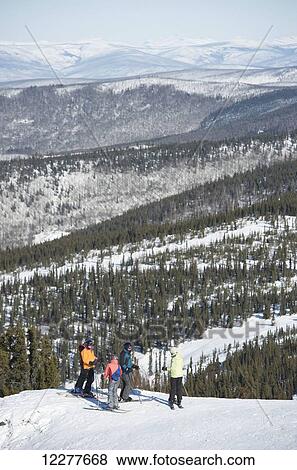 Friends take in the view during a day of downhill skiing at Mt. Aurora Skiland near Cleary Summit north of Fairbanks, Alaska View Large Photo Image Stock Photo - Friends take in the view during a day of downhill skiing at Mt. Aurora Skiland near Cleary Summit north of Fairbanks, Alaska. Fotosearch