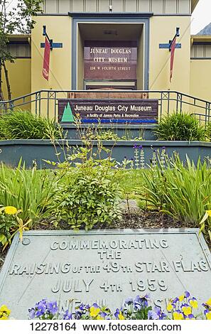 Front entrance of Juneau Douglas City Museum in Juneau with plaque commemorating the raising of the Alaska flag on July 4th, 1959, Southeast Alaska, summer View Large Photo Image Picture - Front entrance of Juneau Douglas City Museum in Juneau with plaque commemorating the raising of the Alaska flag on July 4th, 1959, Southeast Alaska, summer. Fotosearch