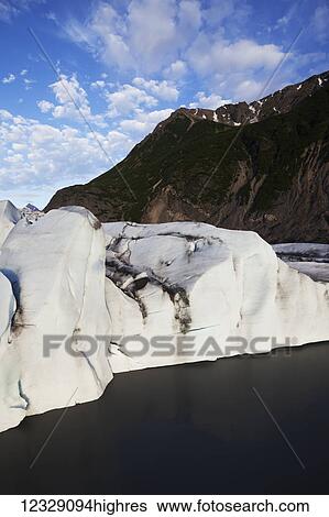 Stock Photograph - Frozen cliffs of ice and snow along the coastline of Kachemak Bay State Park; Alaska, United States of America. Fotosearch
