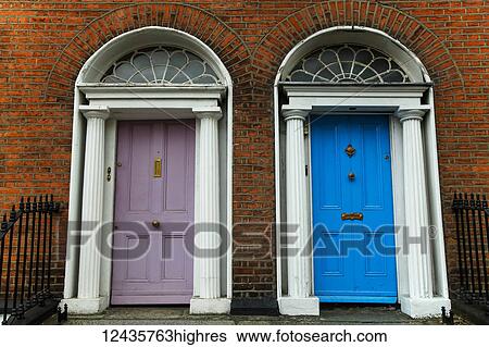 Stock Photograph - Georgian architecture and painted house doors with red brick facade in Dublin city centre; Dublin, Leinster, Ireland. Fotosearch